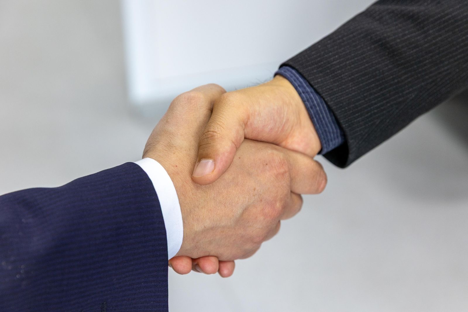 Two people shaking hands in a business meeting