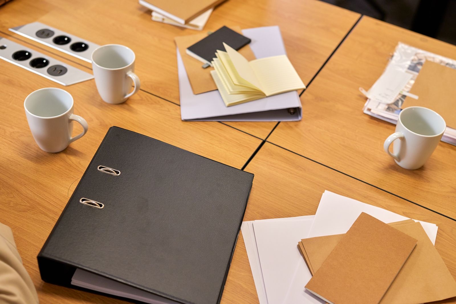 Ring binder and notebooks on an office desk
