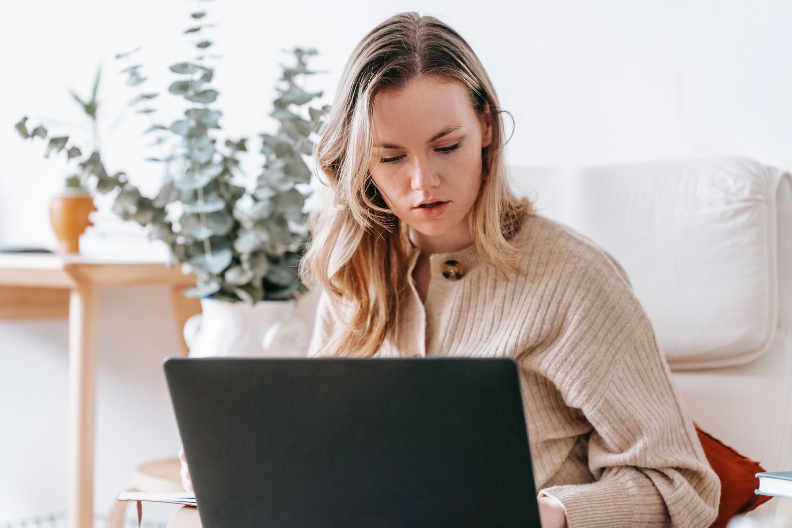 A person working on a laptop at home